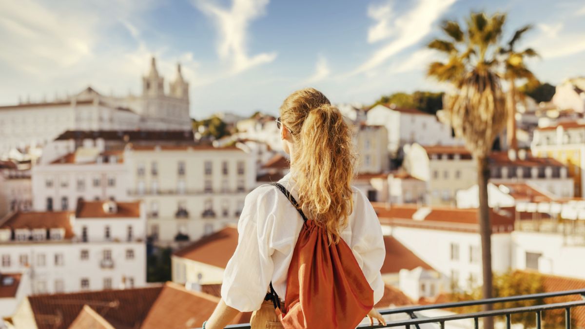Adult admiring view of town in Lisbon Portugal.