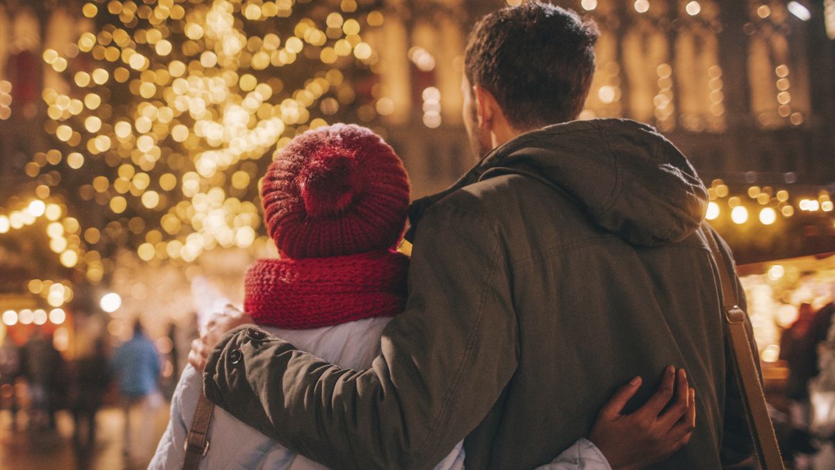 Young adults enjoying the decorations at a Christmas market.