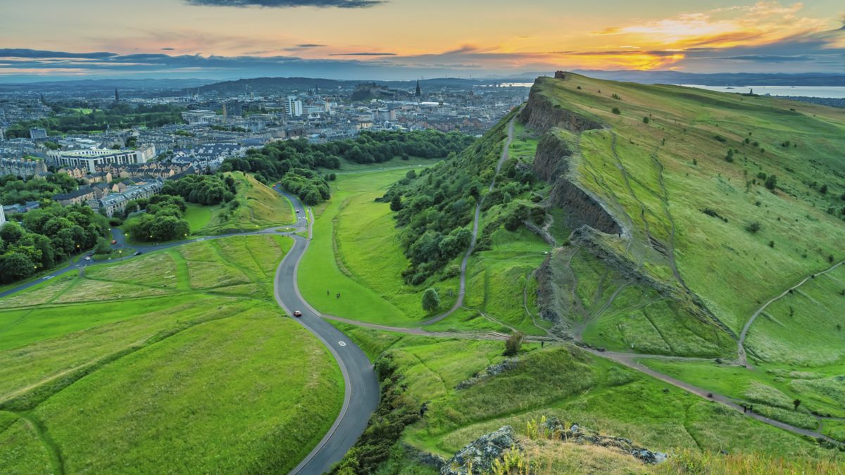 Salisbury Crags and Holyrood Park in Edinburgh Scotland at sunset.