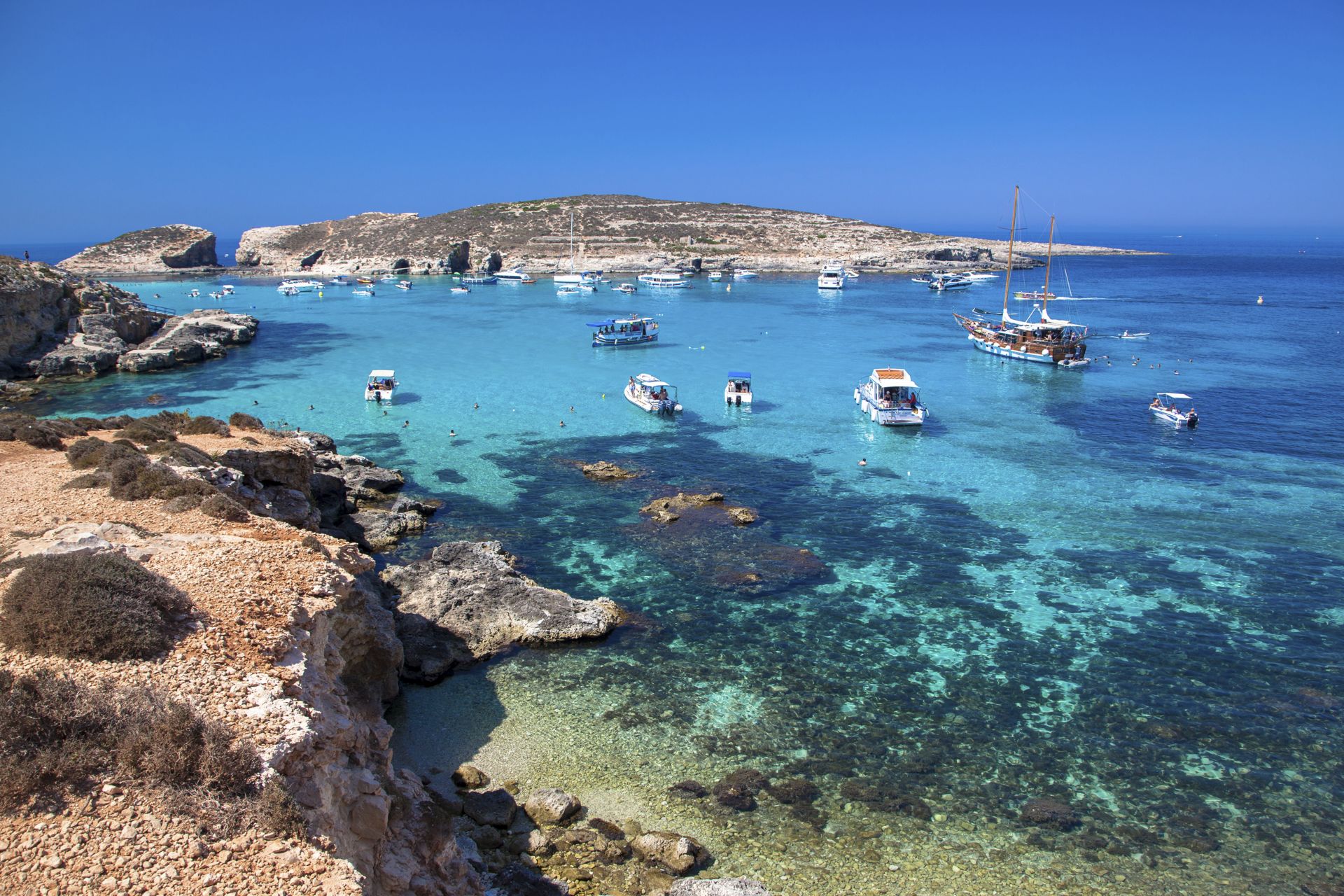 Boats floating in the Blue Lagoon at Comino island in Gozo.