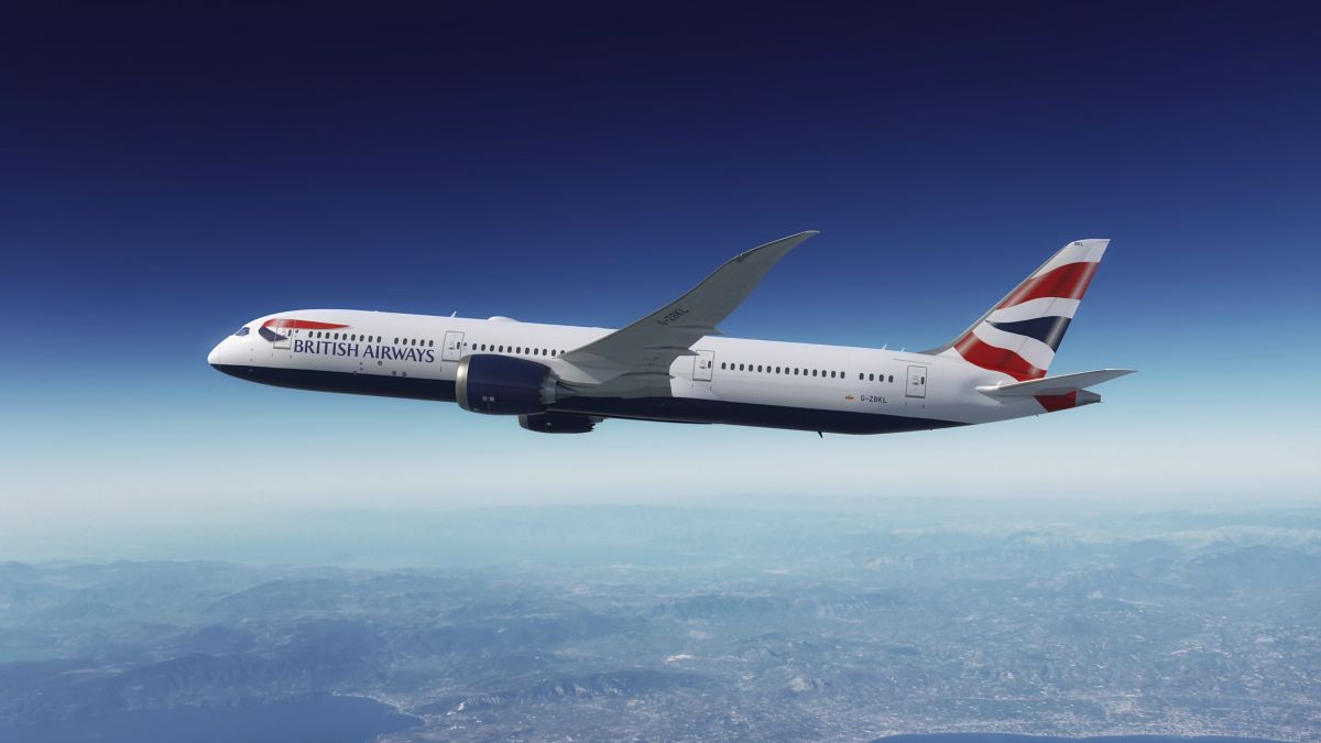 British Airways Boeing 787-9 in flight above coastline.