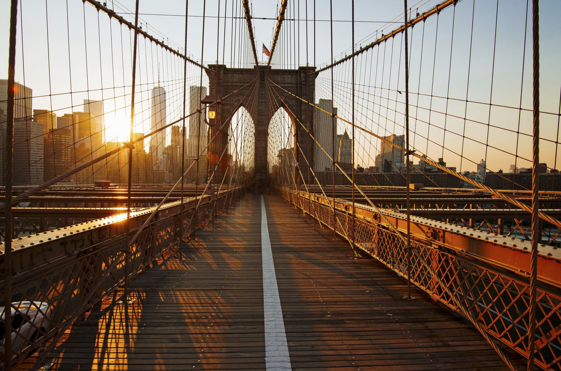 Brooklyn Bridge footpath at sunrise in New York.