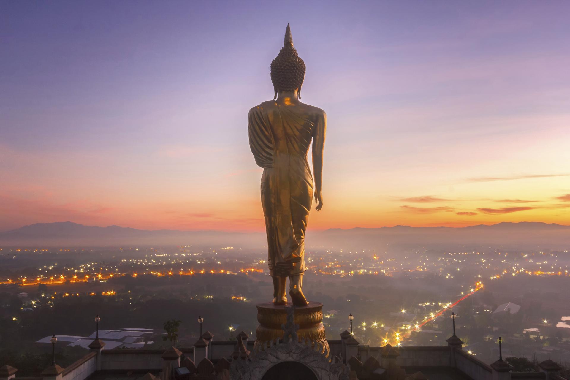 Golden buddha statue at Khao Noi temple at sunrise time in Hua Hin.