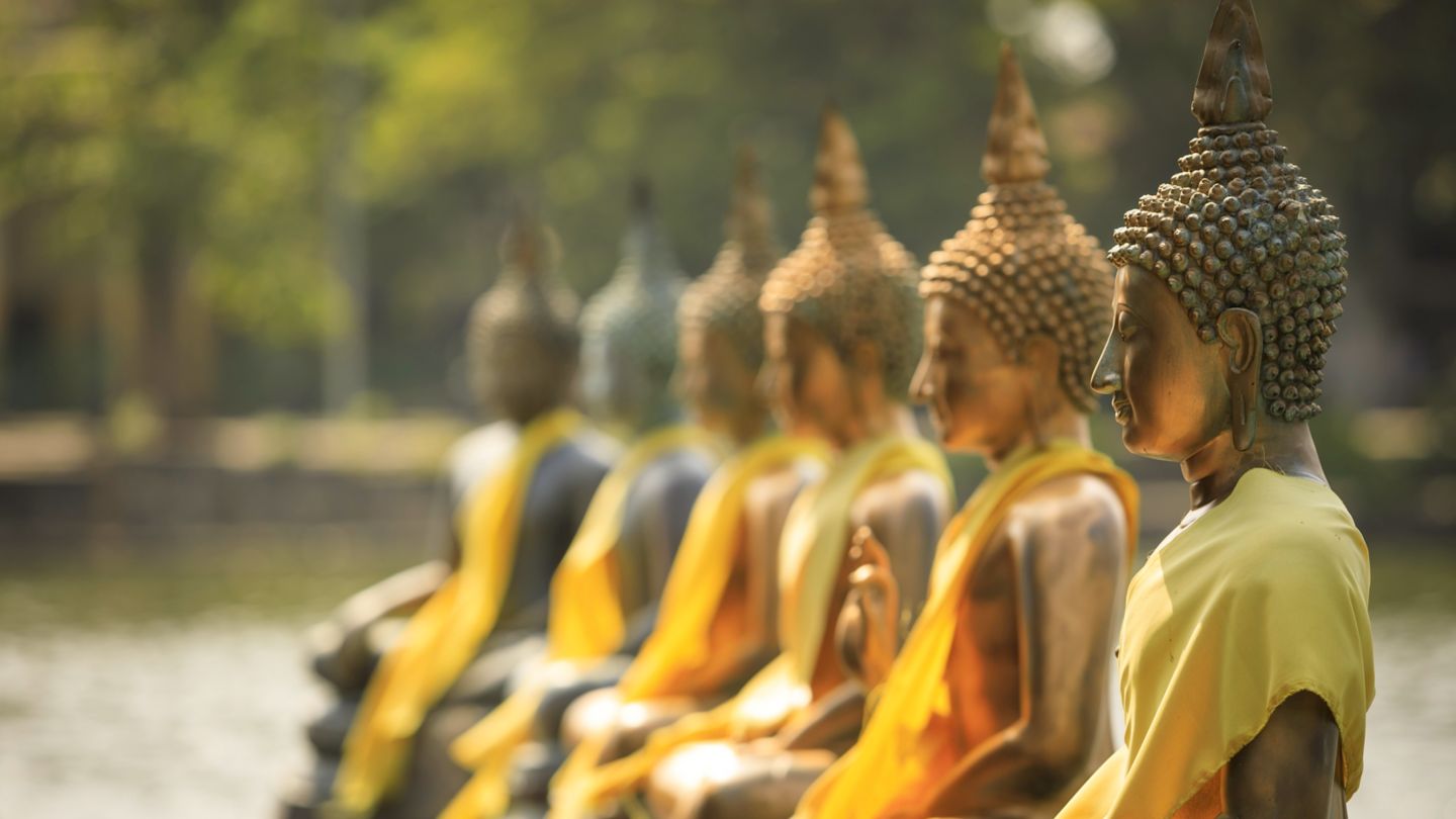 A row of bright Buddha statues at the Buddhist temple near Beira Lake in Colombo. 