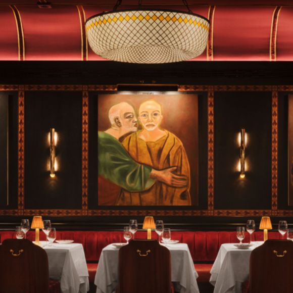 Tables laid in the intimate interior of Carbone, linking to BA High Life site.