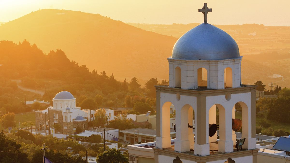 Sunset view of church belfry from Asfendiou village in Kos.