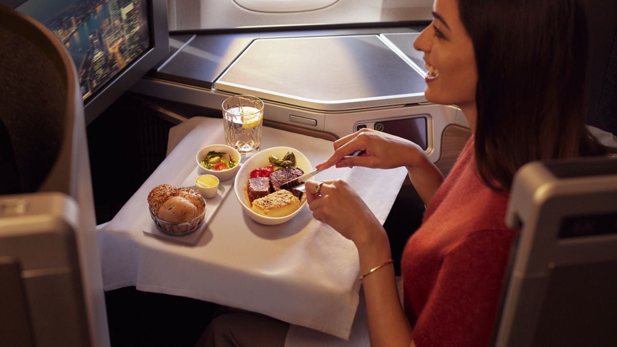 Customer having dinner on British Airways Club World cabin class.
