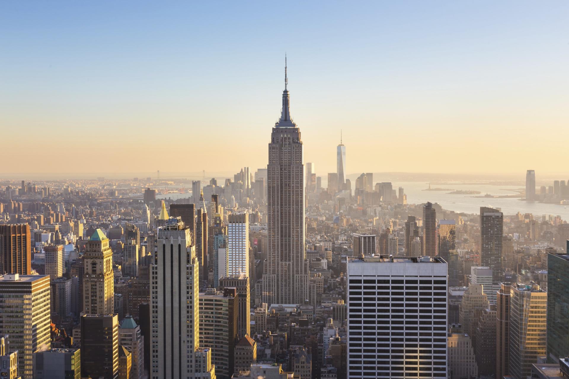 View of Manhattan Empire State Building and Manhattan skyline at sunset from Top of the Rock observation deck in New York.