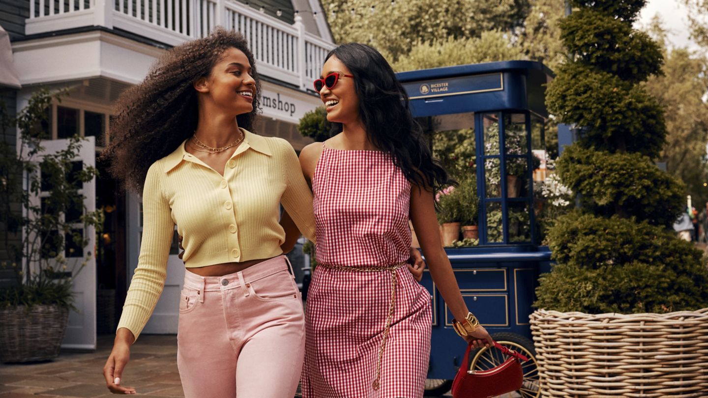 Two friends enjoying shopping in Bicester Village.