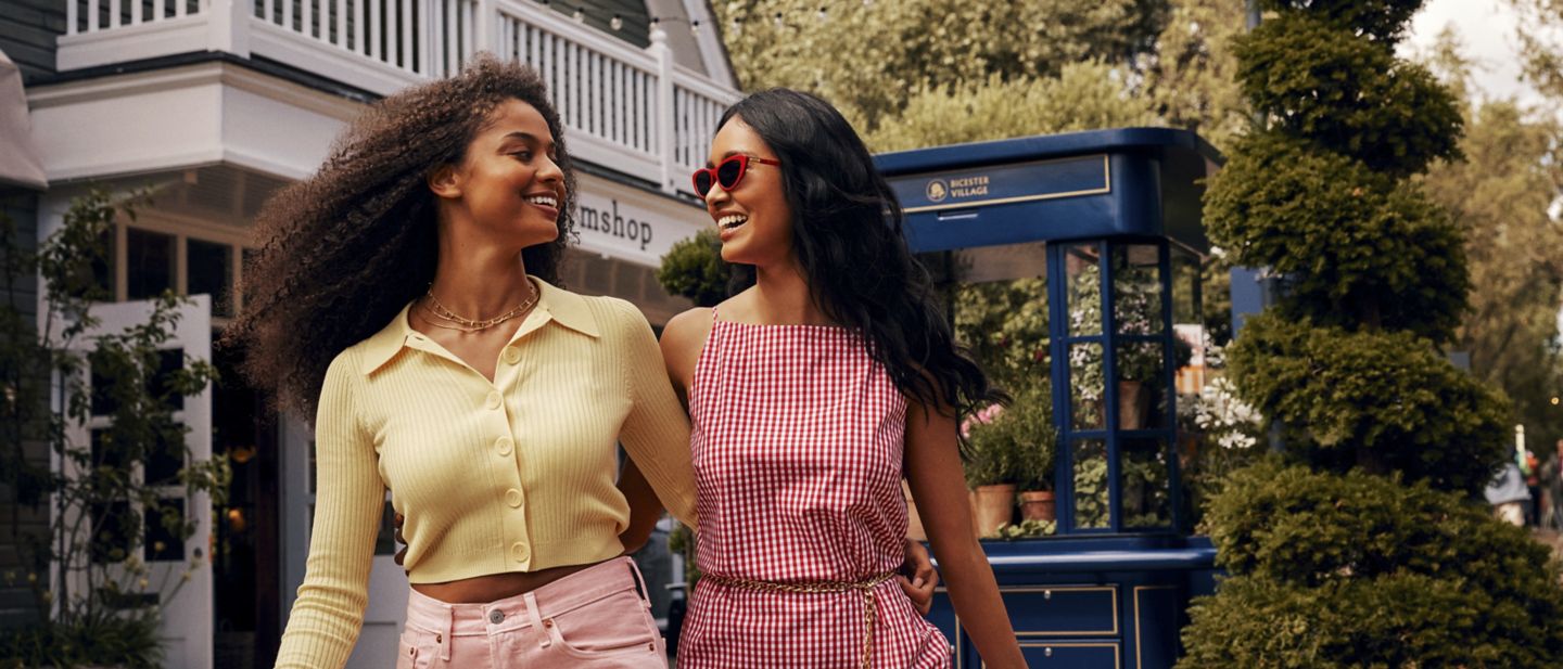 Two friends enjoying shopping in Bicester Village.
