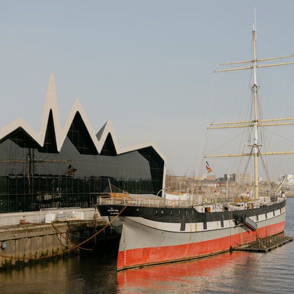 A tall ship outside the Riverside Museum in Glasgow, linking to BA High Life site.