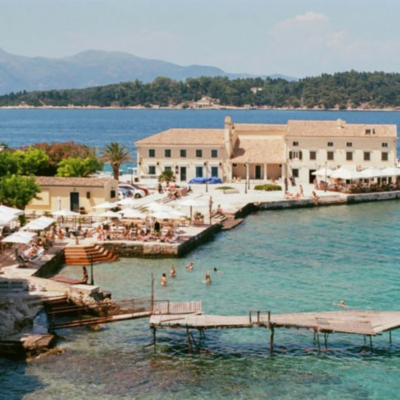 A sunny day at Faliraki Beach in Corfu Town, Greece, linking to BA High Life site.