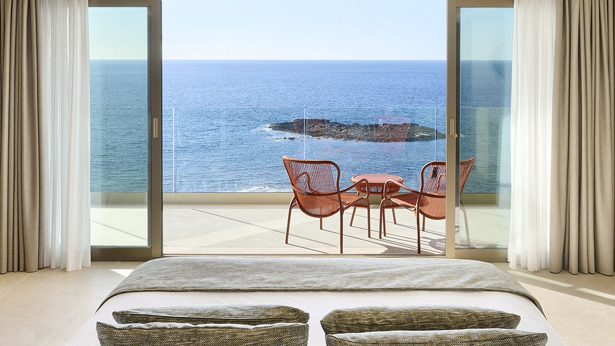 Chairs set up on a balcony looking out across impressive sea views from an Iberostar Beachfront Resort, links to BA High Life .com.