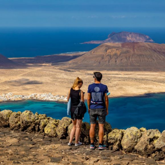 Two people admiring the view at Mirador del Río in Lanzarote, linking to BA High Life site.