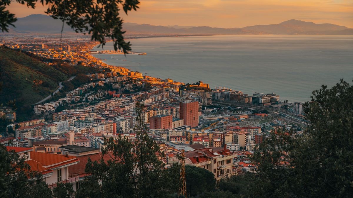 Panoramic view across the Salerno coastline and Tyrrhenian sea beyond at sunset, links to BA High Life.com.