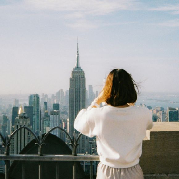 A visitor looking out across the Manhattan skyline, linking to BA High Life website.
