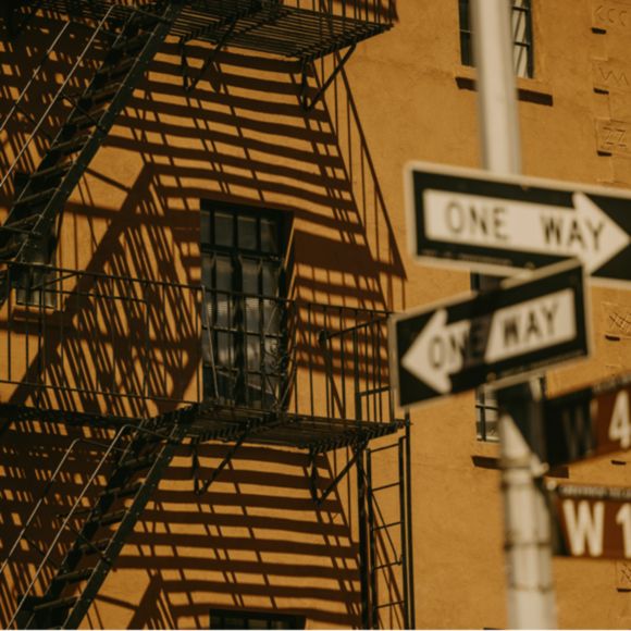 Stairs running up the side of a building and street signs in New York, linking to BA High Life site.