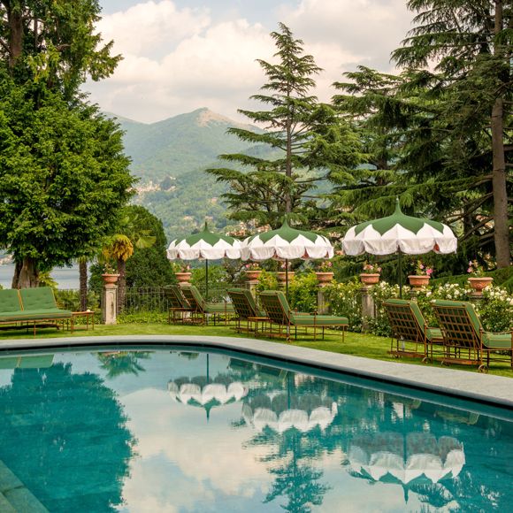 Loungers lining the pool at Passalacqua hotel in Moltrasio, linking to BA High Life website.