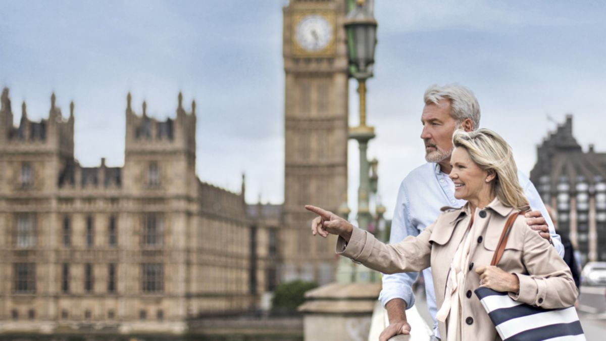 Couple walking by Big Ben in London.