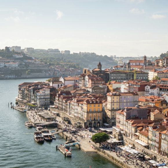View over the city of Porto and the Douro River on a sunny day, linking to BA High Life website.