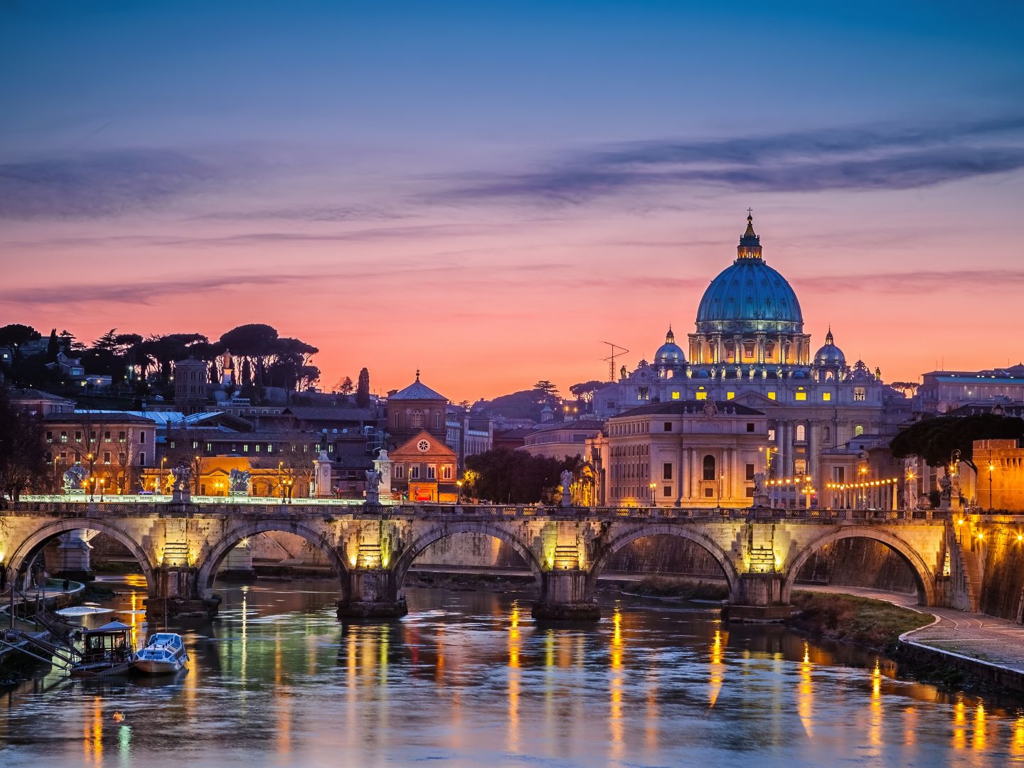 St Peter's Basilica illuminated at night in Rome.