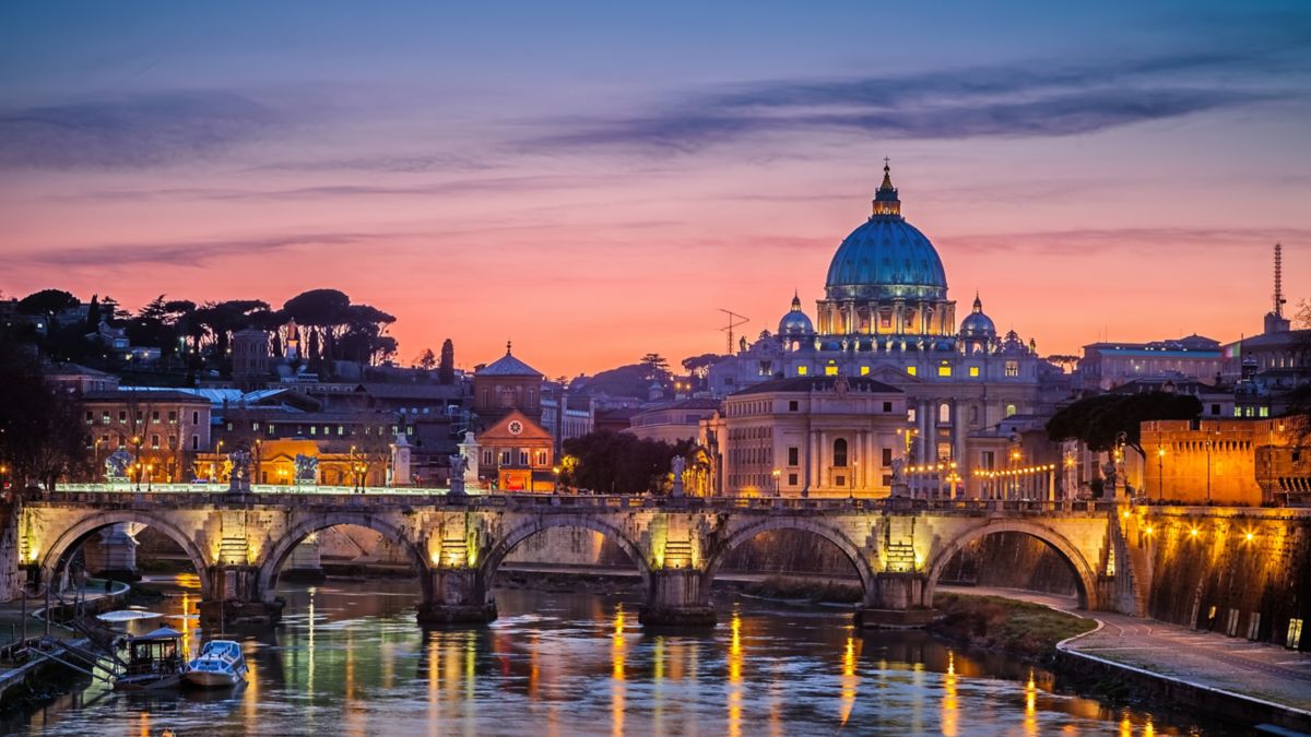 St Peter's Basilica illuminated at night in Rome.