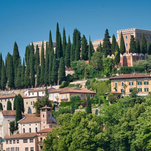 The tree-lined Castel San Pietro in Verona, linking to BA High Life website. 
