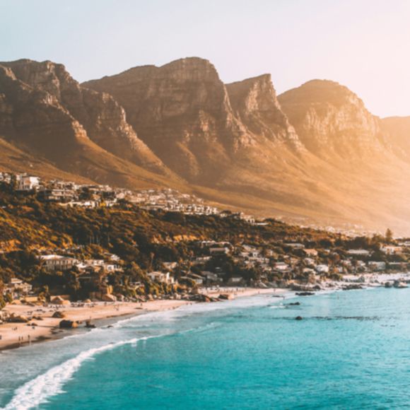 Golden sunlight on the mountains of Cape Town, linking to www.bahighlife.com.