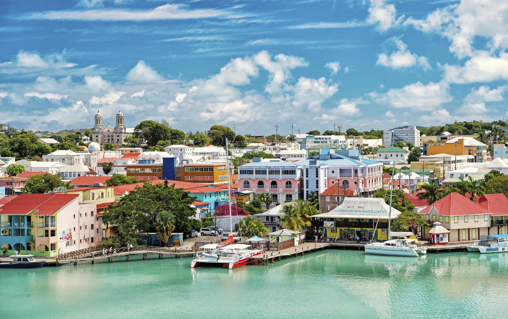 Yachts on the harbour amongst houses in St John in Antigua.